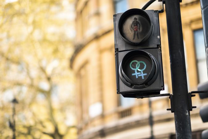 "Go" green pedestrian lights with 2 intersecting female gender symbol