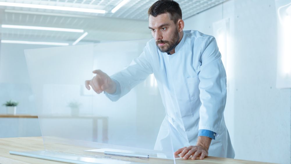 In the Futuristic Laboratory Male Scientist Works on His Transparent Computer Display Great for Mock-up Template, like Chroma Key.
