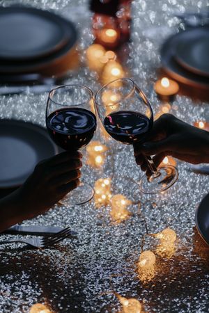 Two wine glasses making cheers at holiday table
