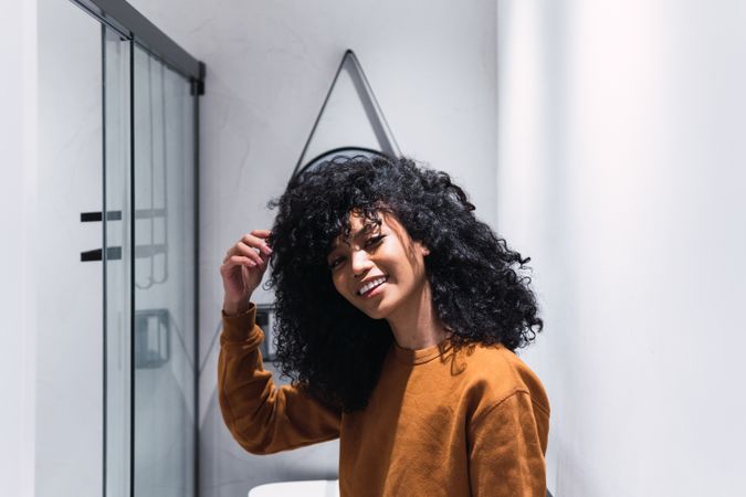 Smiling Black woman with curly hair