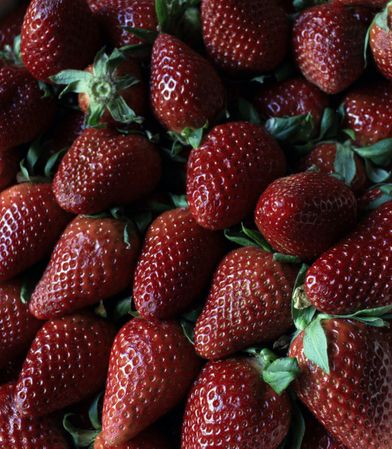 Heap of ripe strawberries with leaves