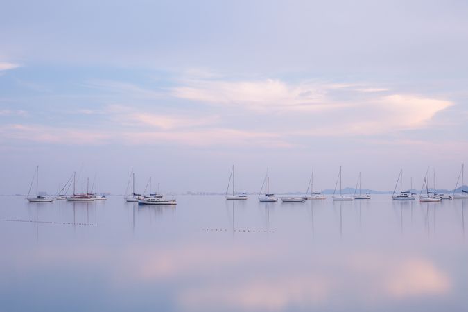 Boats on calm sea water in evening