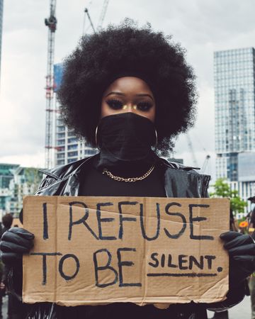 London, England, United Kingdom - June 6th, 2020: Woman with afro holding sign at BLM protest
