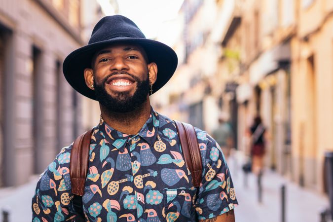 Stylish Black man walking on the city street