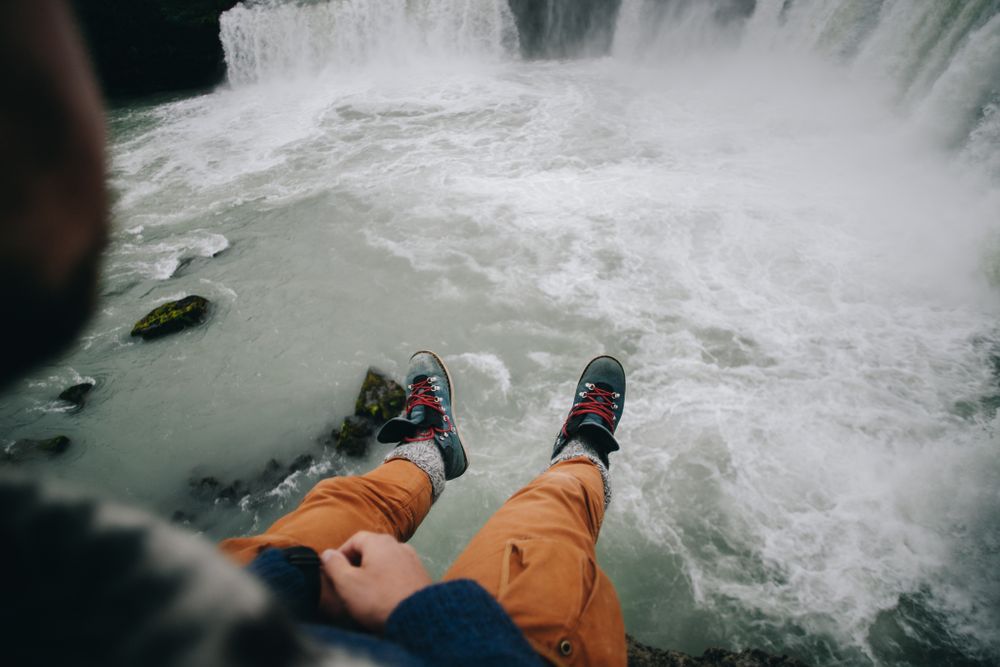 Legs hanging over cliff