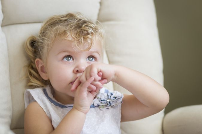 Adorable Blonde Haired Little Girl in Chair