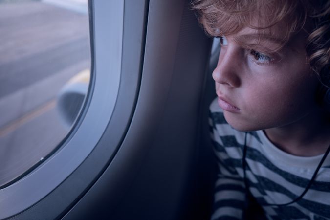 Boy looking out of airplane window
