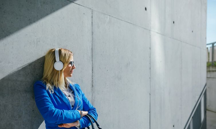 Businesswoman with headphones posing