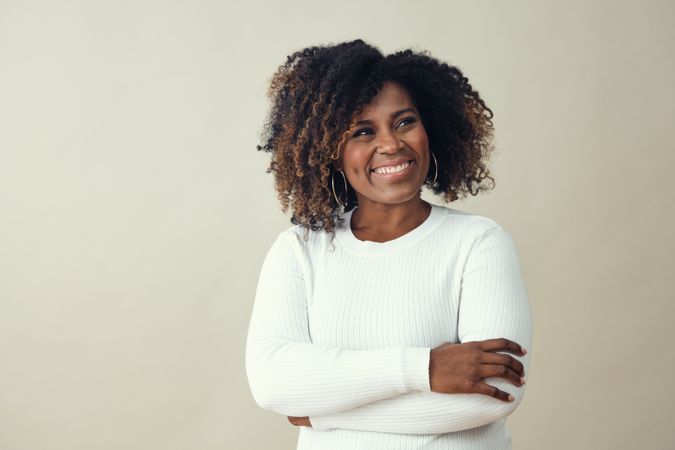 Confident Black woman smiling with her arms crossed