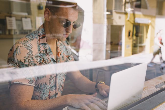 Man working on browsing laptop
