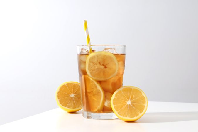 A glass of cold tea with fresh orange slices