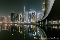 Dubai skyline across body of water during night time showcasing the tallest building Burj khalifa bYJP60