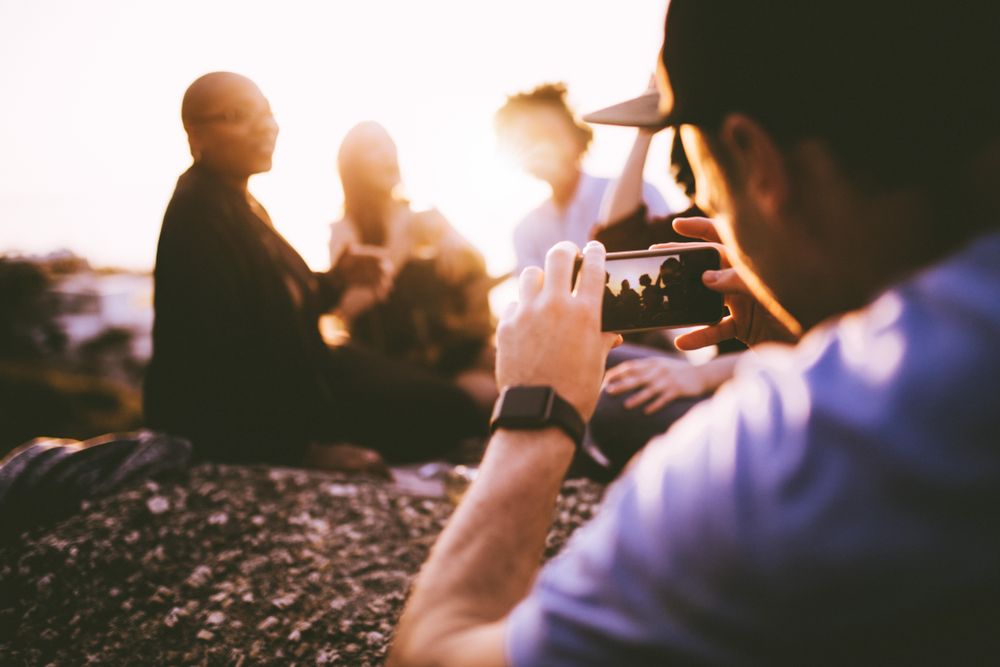 Man taking a photo of his friends