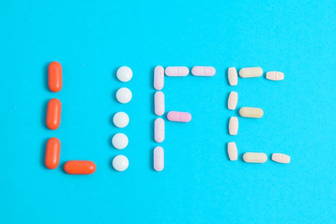 Top view of multiple pills making the word "LIFE"