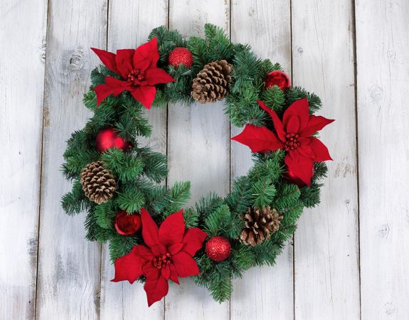 Holiday Poinsettia Christmas wreath on rustic wood