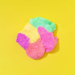 Textured silly putting in different colors smashed together on yellow background