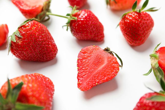 Composition with strawberries on light background, closeup. Summer sweet fruits and berries
