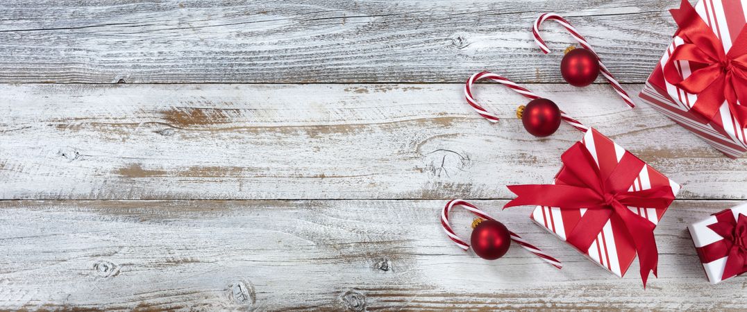 Merry Christmas with gifts and ornaments on weathered wooden background