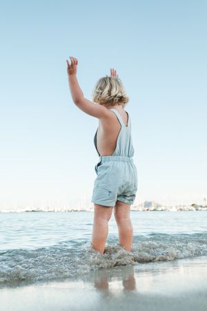 Unrecognizable child standing in sea