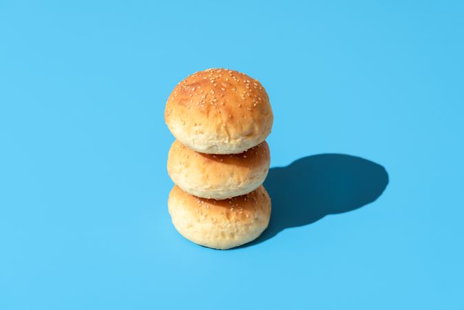 Bread buns in bright light isolated on a blue background
