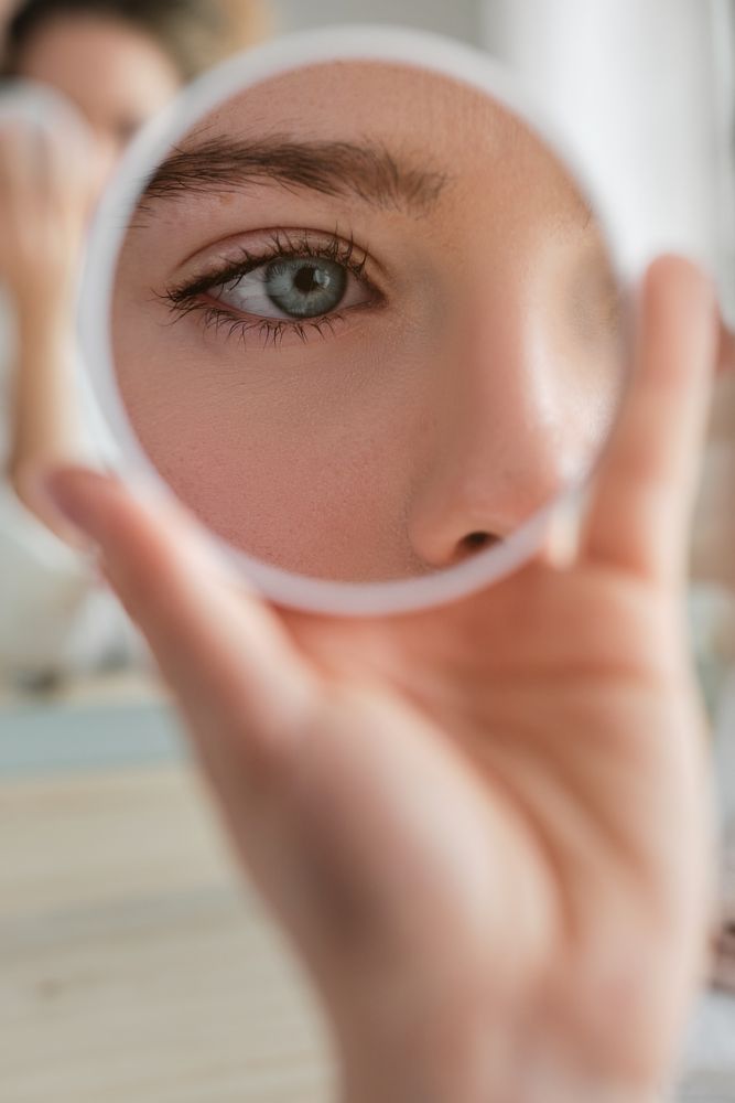 Anonymous woman with round mirror