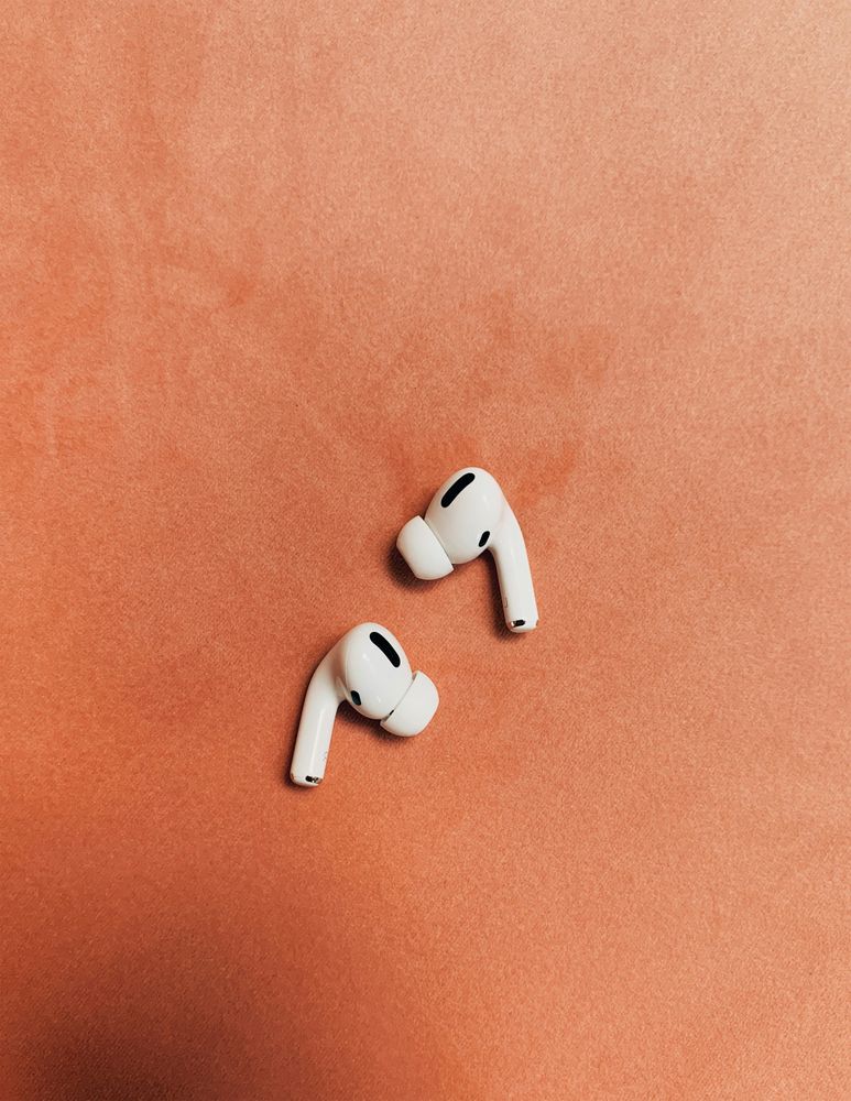 Wireless Earbuds on Orange Background