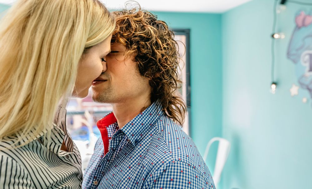 Couple kissing in a cafe
