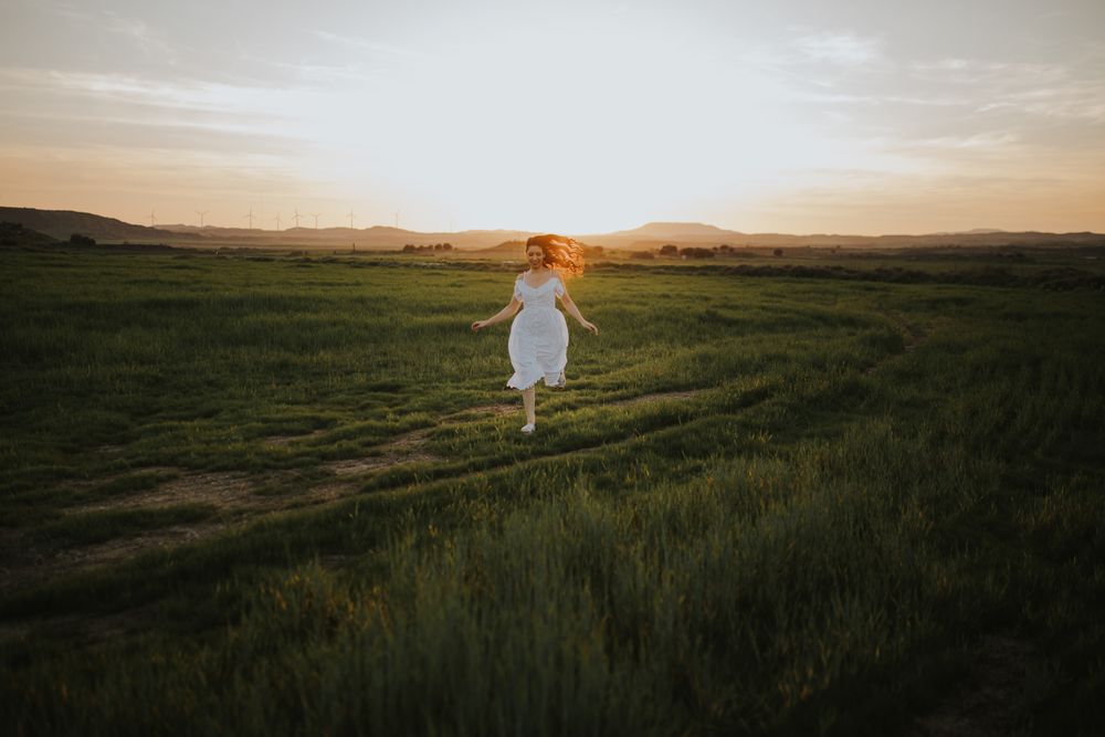 Anonymous woman walking in flower field
