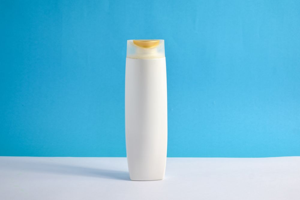 Blank body wash bottle in blue room