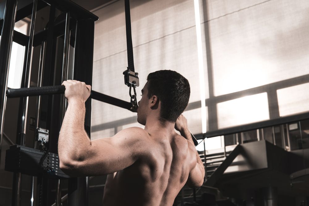 Young fitness man training in gym