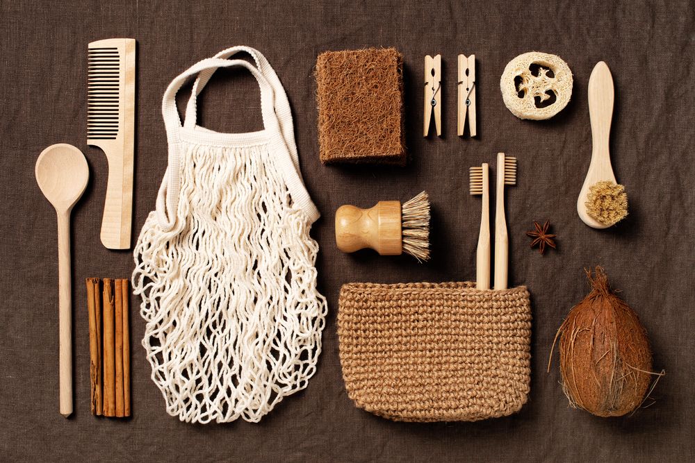 Top view arrangement of eco-friendly supplies on brown textured fabric