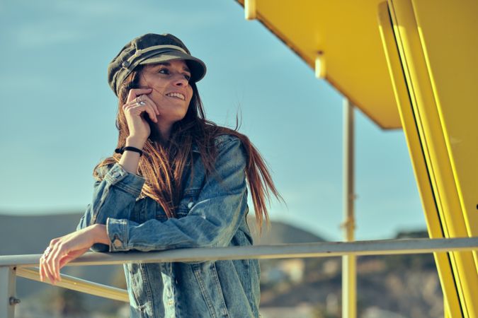 female standing on balcony on nature