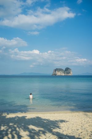 Unrecognizable female in blue sea
