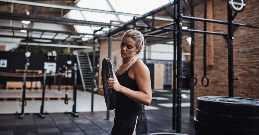 Woman moving weights around gym