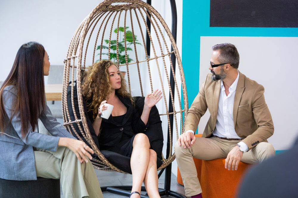 Colleagues talking in relaxing  and colorful corner of office