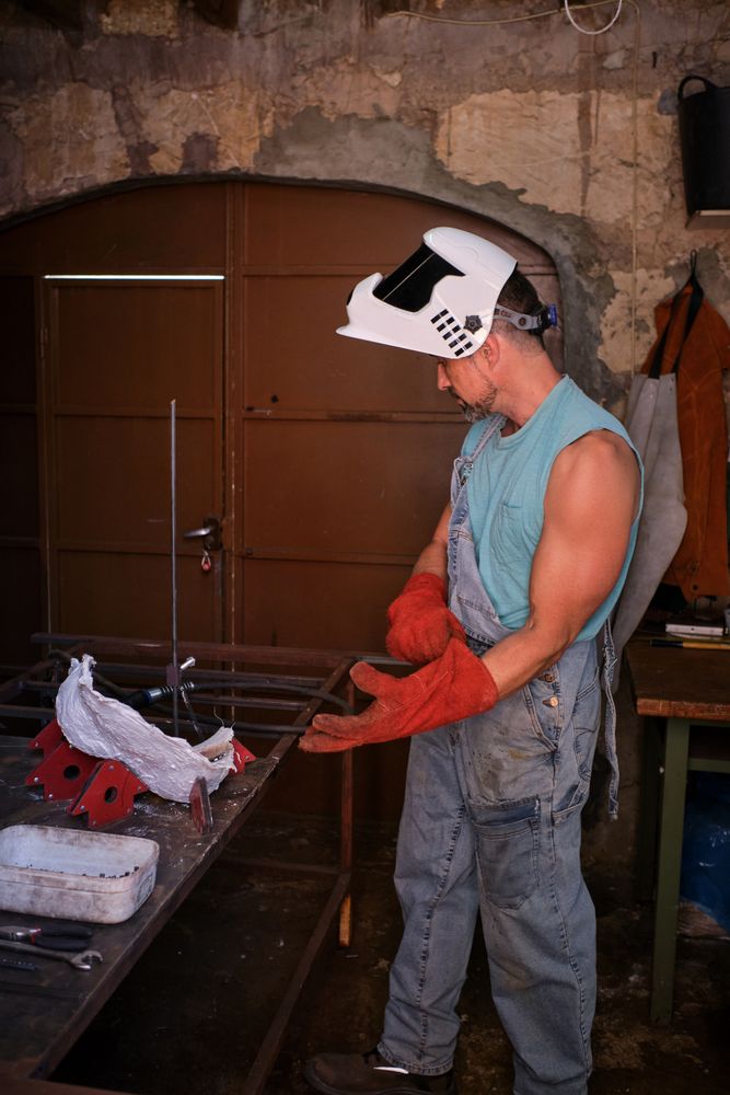 Professional worker wearing gloves in welding workshop