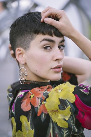 Woman in colorful shirt posing