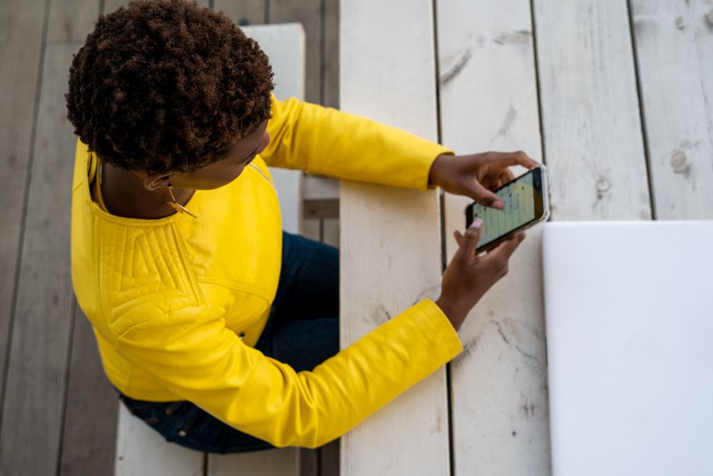 Focused woman using mobile at desk