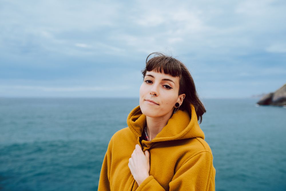 Young woman standing near sea