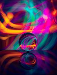 Crystal ball on board near abstract shines