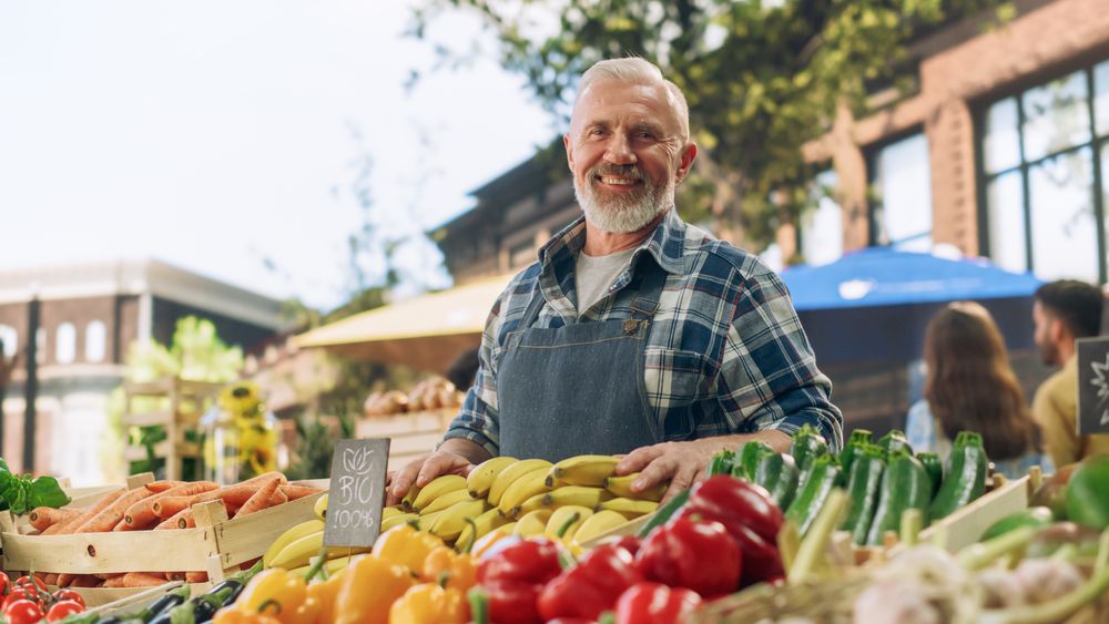 Successful Mature Farmer Posing and Cheerfully Smiling for Camera.