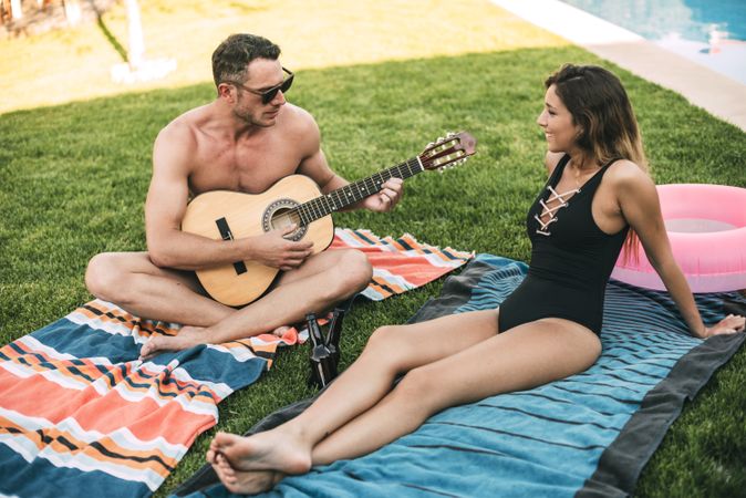 Guy with guitar playing for his girlfriend