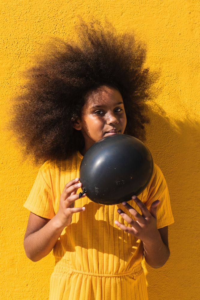 Black girl holding party balloon