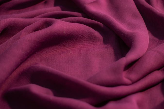 Soft purple fabric wavy spiral crumpled background abstract with copy space in the center