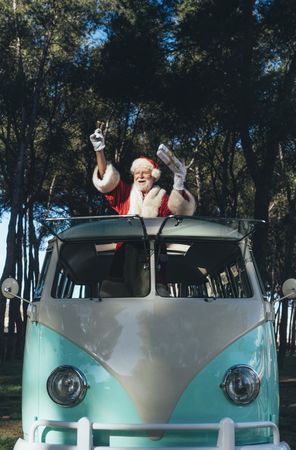 Santa Claus waving from old van