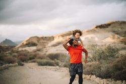 Black father holding child in arms