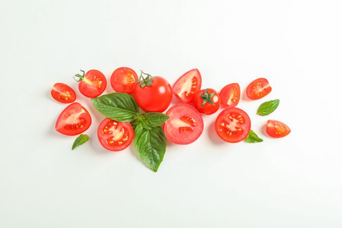 Flat lay composition with fresh cherry tomatoes and basil on blank background, space for text. Ripe vegetables