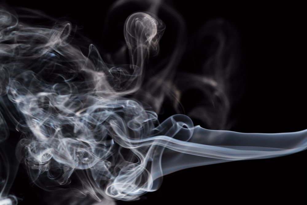 Abstract smoke moving on dark background