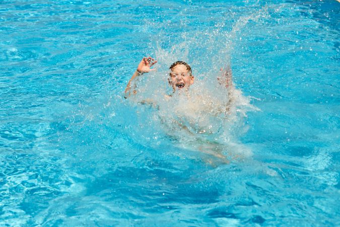 Kid jumping in swimming pool