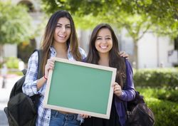 Female Students Holding Blank Chalkboard